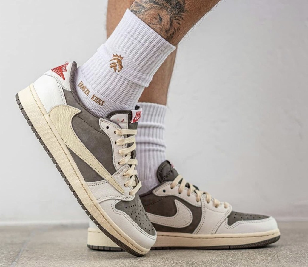 Travis Scott Reverse Mocha trainers on feet with white socks